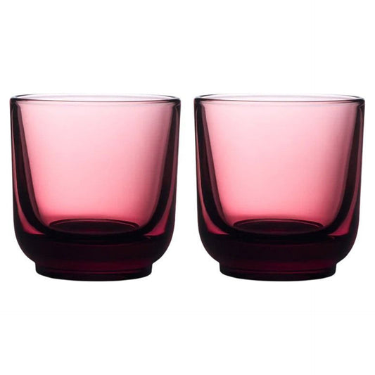 Two garnet coloured glass tumblers on a white background