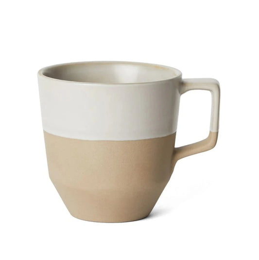 Two-toned beige and white mug on a white background
