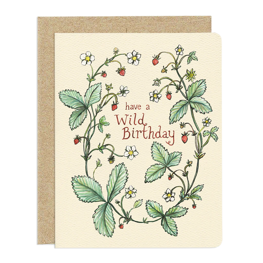 The card itself is a light, creamy yellow color with rounded corners.
The design of the card is an illustration of wild strawberry plants. The plants form an organic u-shaped arrangement, framing the text "have a wild birthday". 

The leaves are depicted in various shades of green, with detailed serrated edges and visible veins. Small, delicate white flowers with yellow centers are scattered throughout the foliage, along with tiny red strawberries, some ripe and others still developing.

