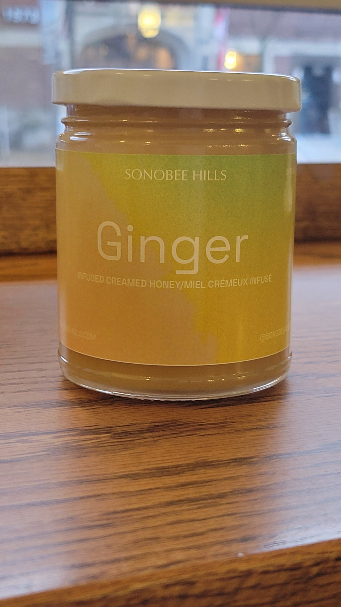 Jar of ginger honey on a wooden surface